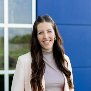 Professional headshot of ATN Board Member Amanda Foust smiling against a blue house background.