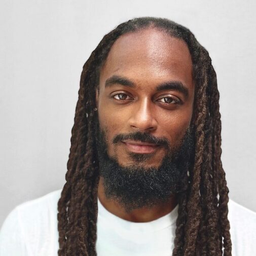 Headshot of Martin Ali Simms, trauma-informed athletics specialist, founder of The DOPE Coach Academy, and Board Member at the Attachment and Trauma Network (ATN).