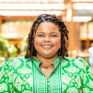 Professional portrait of ATN Board Member Tori Mabry smiling in business attire against a blue background.